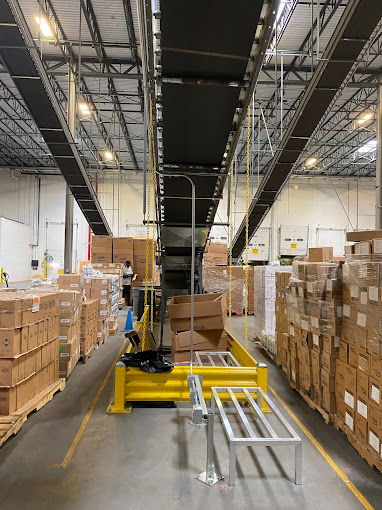 A warehouse filled with lots of boxes and a fork lift